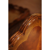 Close-up of carved edge on mahogany bed frame.