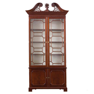 Chippendale-style scroll top bookcase with glass doors.
