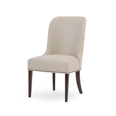 Beige art deco dining chair with dark wood legs, angled view.