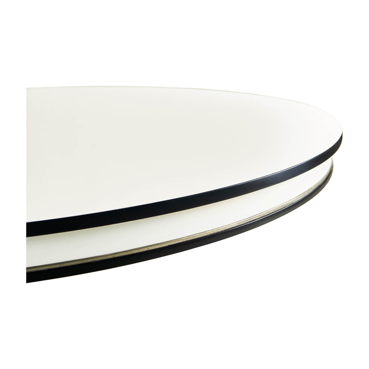 Close-up of round table edge, black and white contrast.