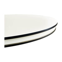 Close-up of round table edge, black and white contrast.