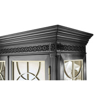 Black cabinet, detailed view of ornate trim design.