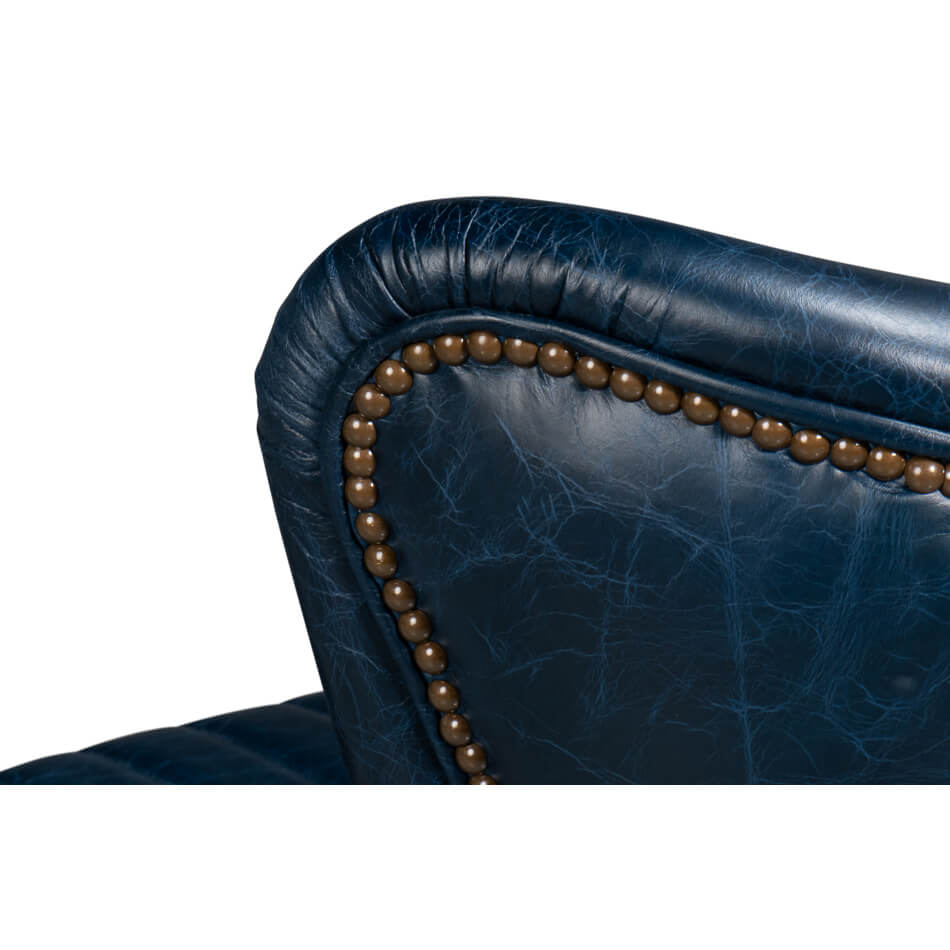Blue leather swivel chair, nailhead trim detail, armrest focus.