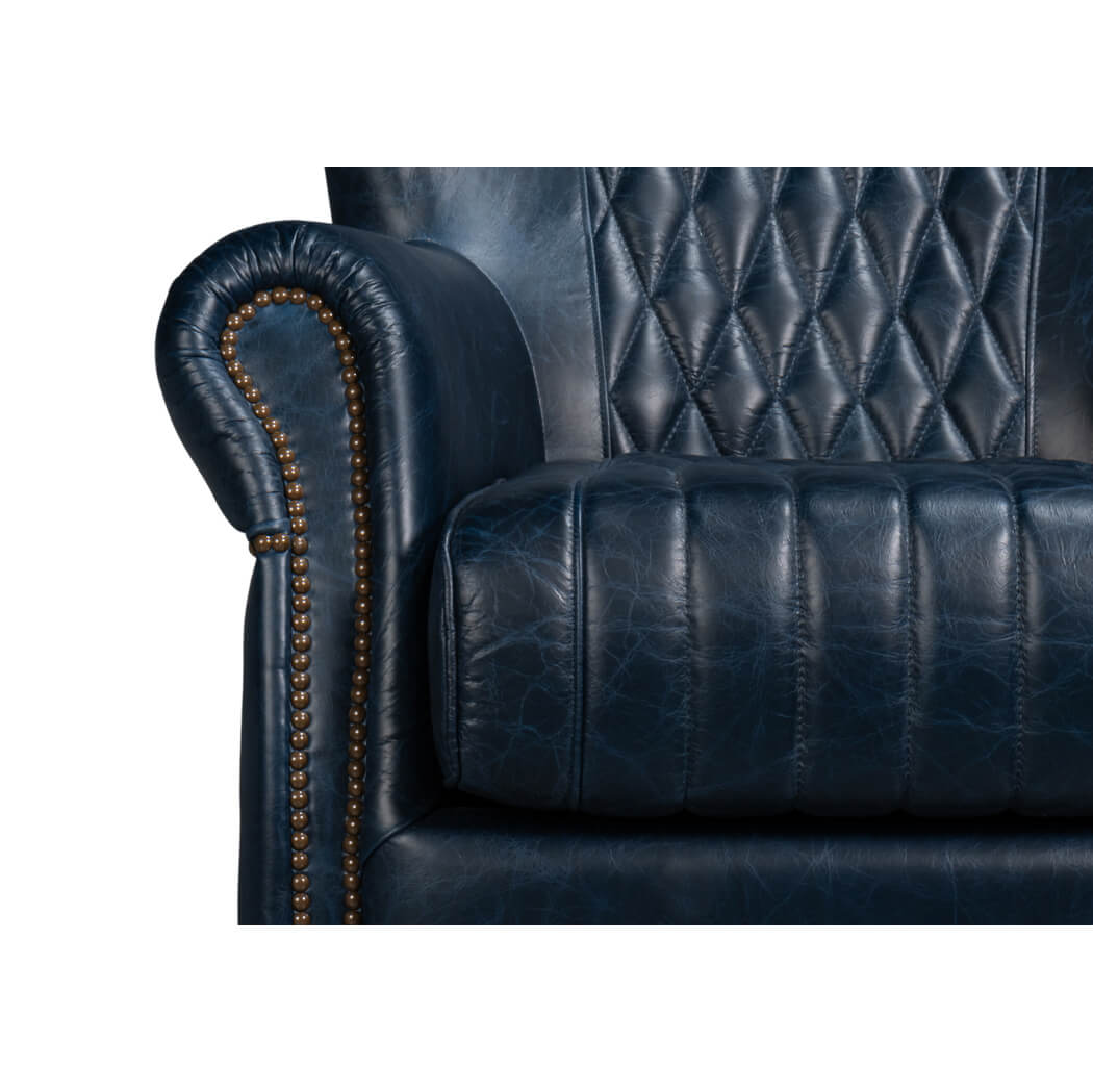 Blue leather swivel chair, close-up, armrest and seat stitching.