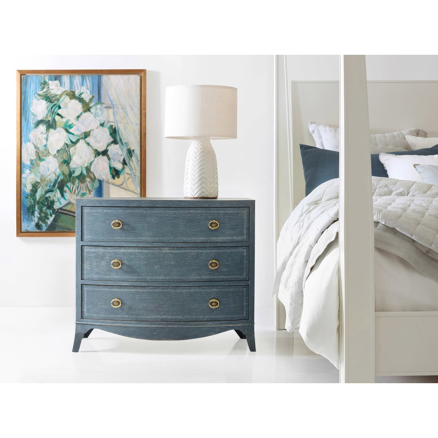 Blue bedside chest in stylish bedroom decor setting.