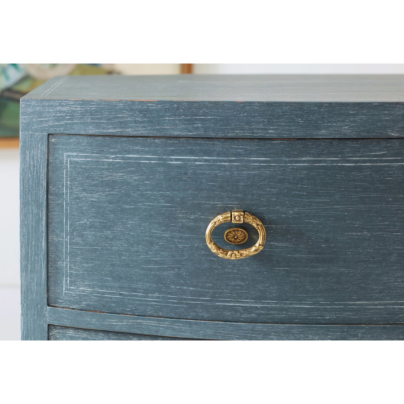 Close-up of bedside chest drawer with golden handle.