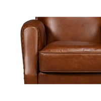 Brown leather swivel armchair armrest close-up.