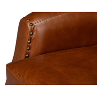 Brown leather swivel armchair seat and arm detail.
