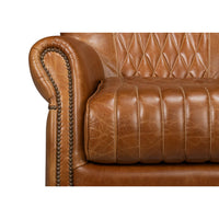 Detailed armrest with nailhead trim on swivel chair