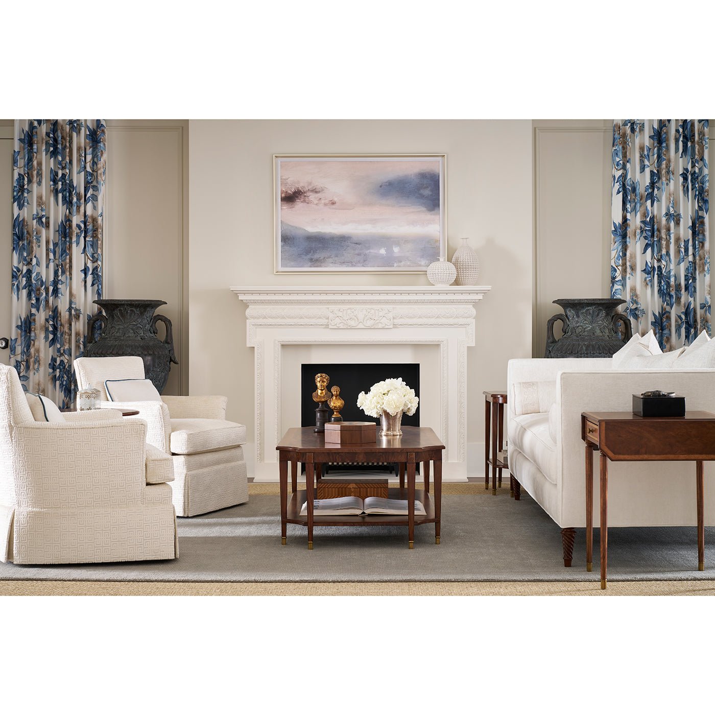 Coffee table in elegant living room, white furniture and fireplace.