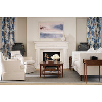 Coffee table in elegant living room, white furniture and fireplace.