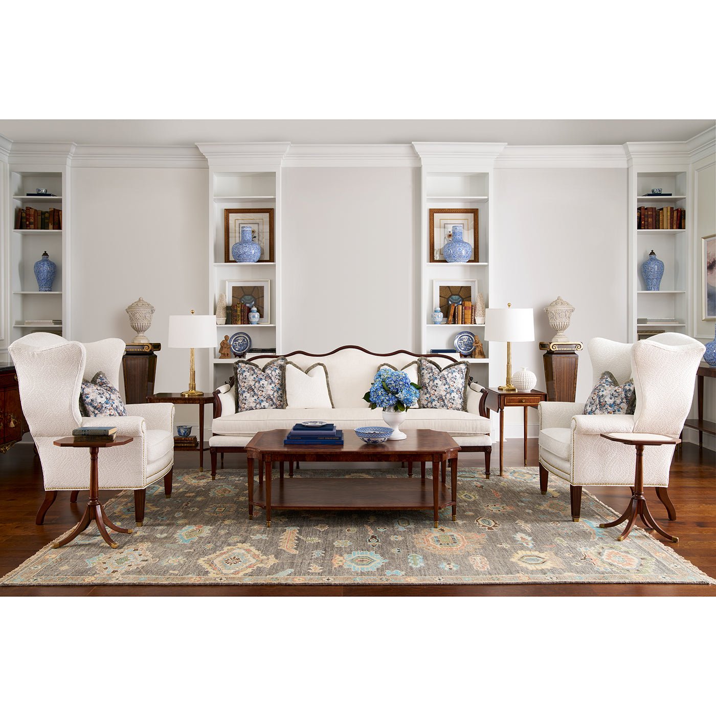 Coffee table in modern living room with white chairs.