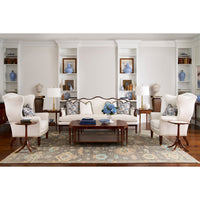 Coffee table in modern living room with white chairs.