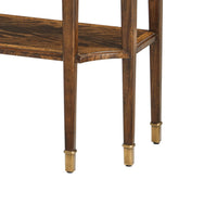 Classic console table leg design featuring gold-tipped feet.