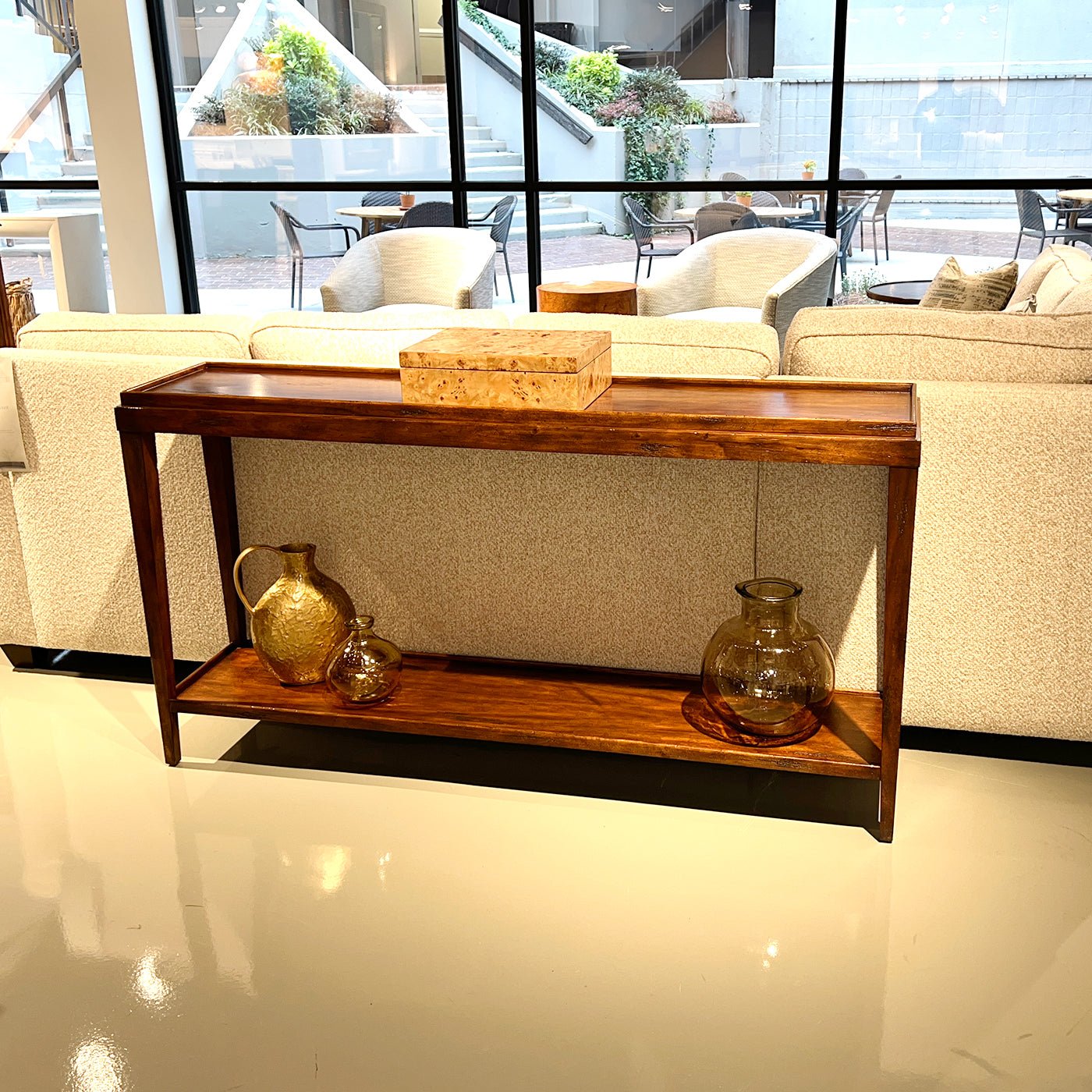 Console table with decor, displayed in modern living room.