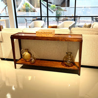 Console table with decor, displayed in modern living room.
