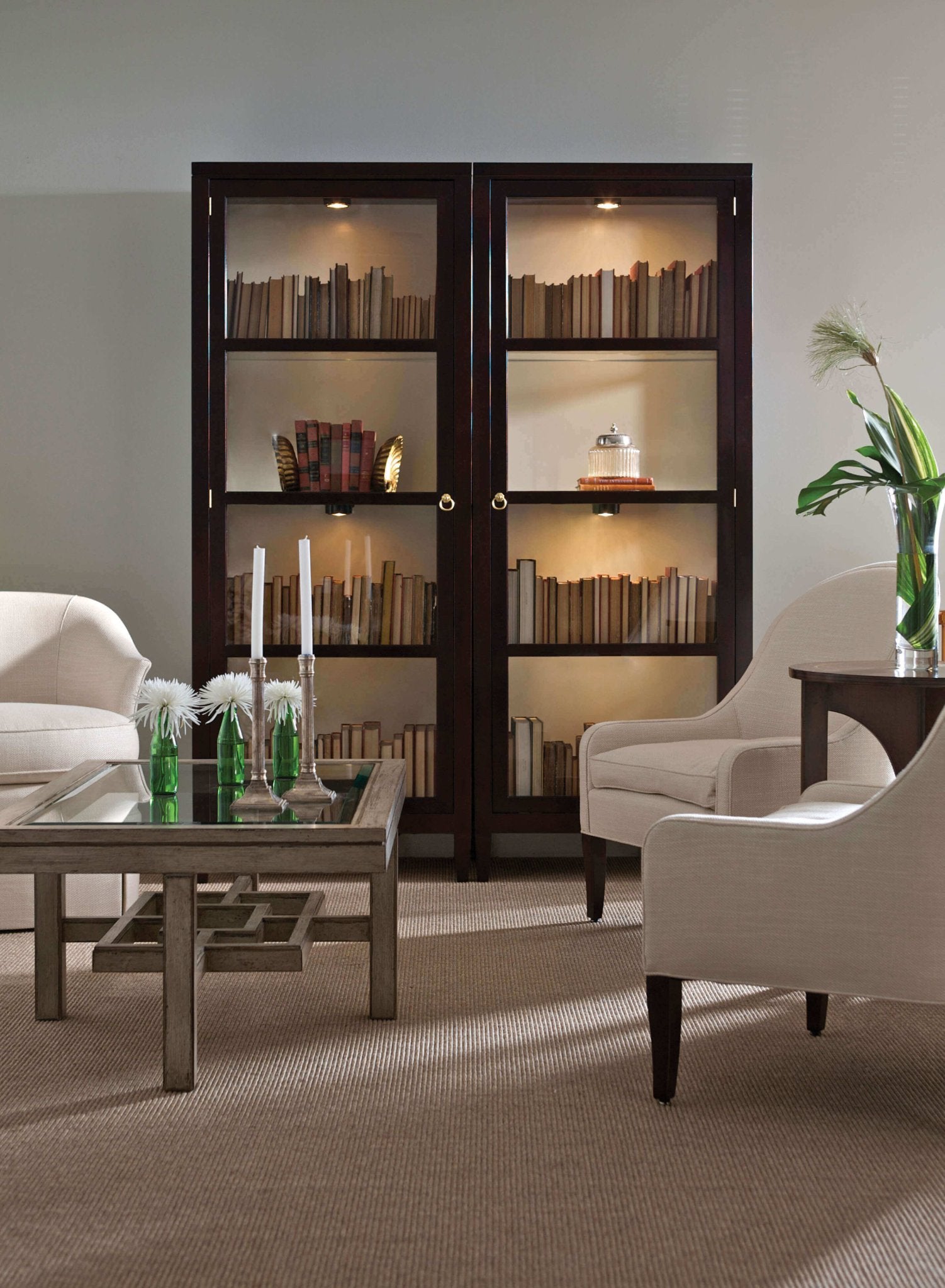Two curio cabinets in elegant living room setting.