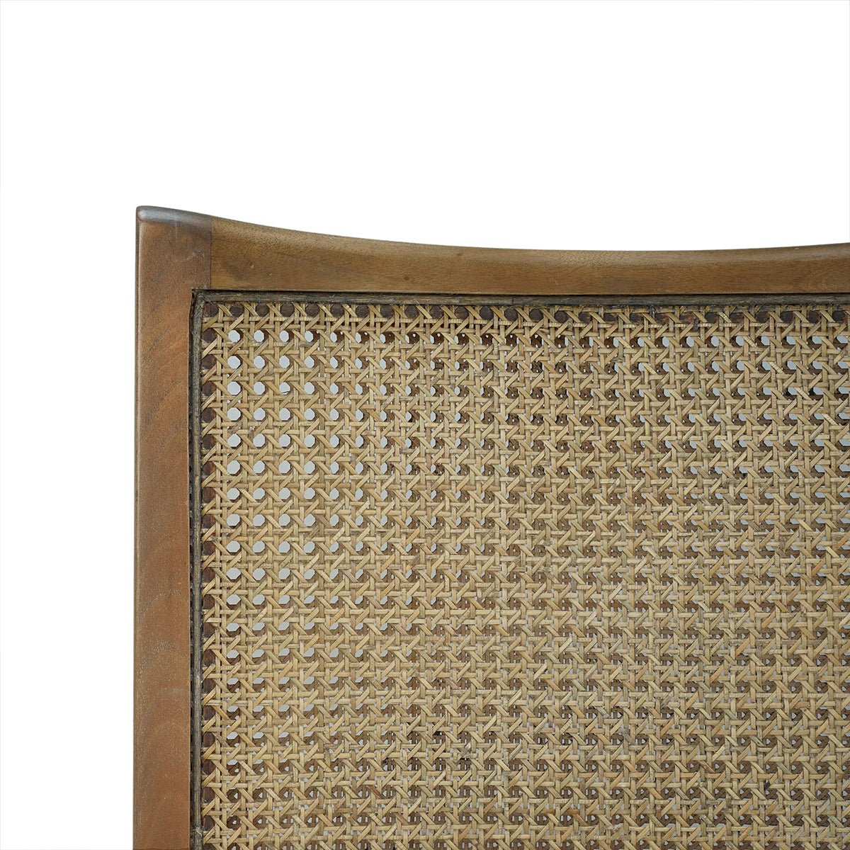 Close-up of cane back on wooden dining chair.