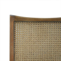 Close-up of cane back on wooden dining chair.