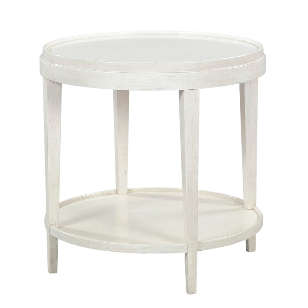 Round white end table with lower shelf, angled view.