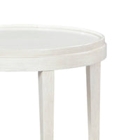 Close-up of white round table edge and legs.