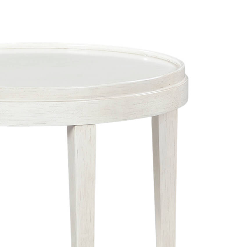 Close-up of white round table edge and legs.