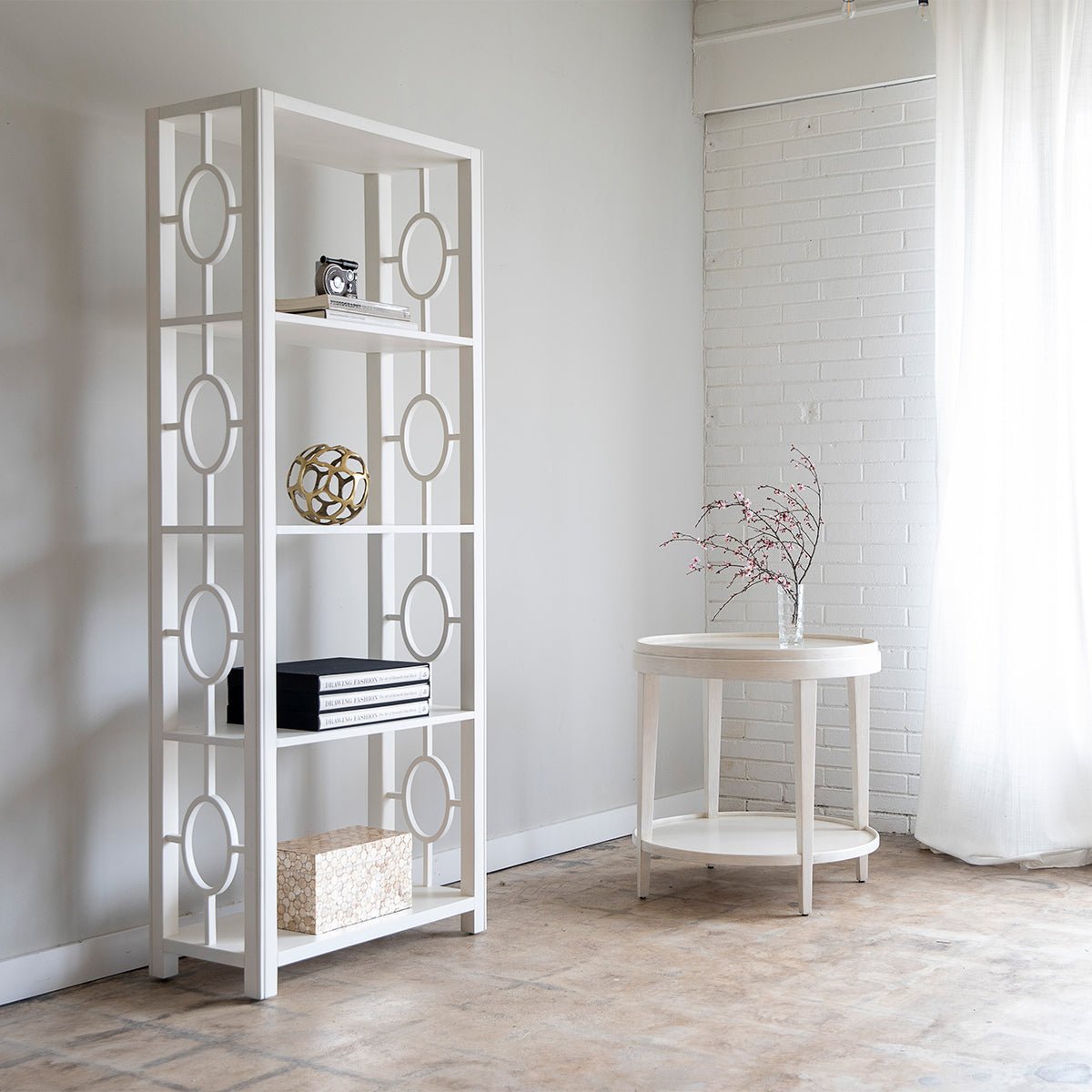 White end table in minimalistic room setting near shelf.