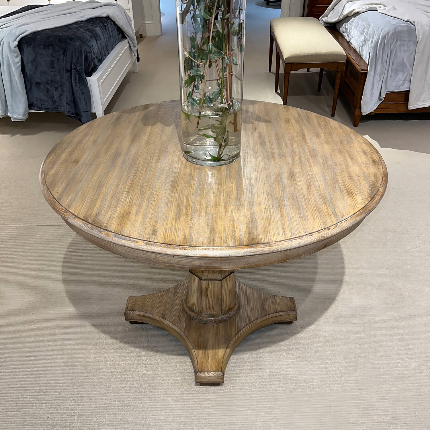 Center table with decorative vase in showroom setting.