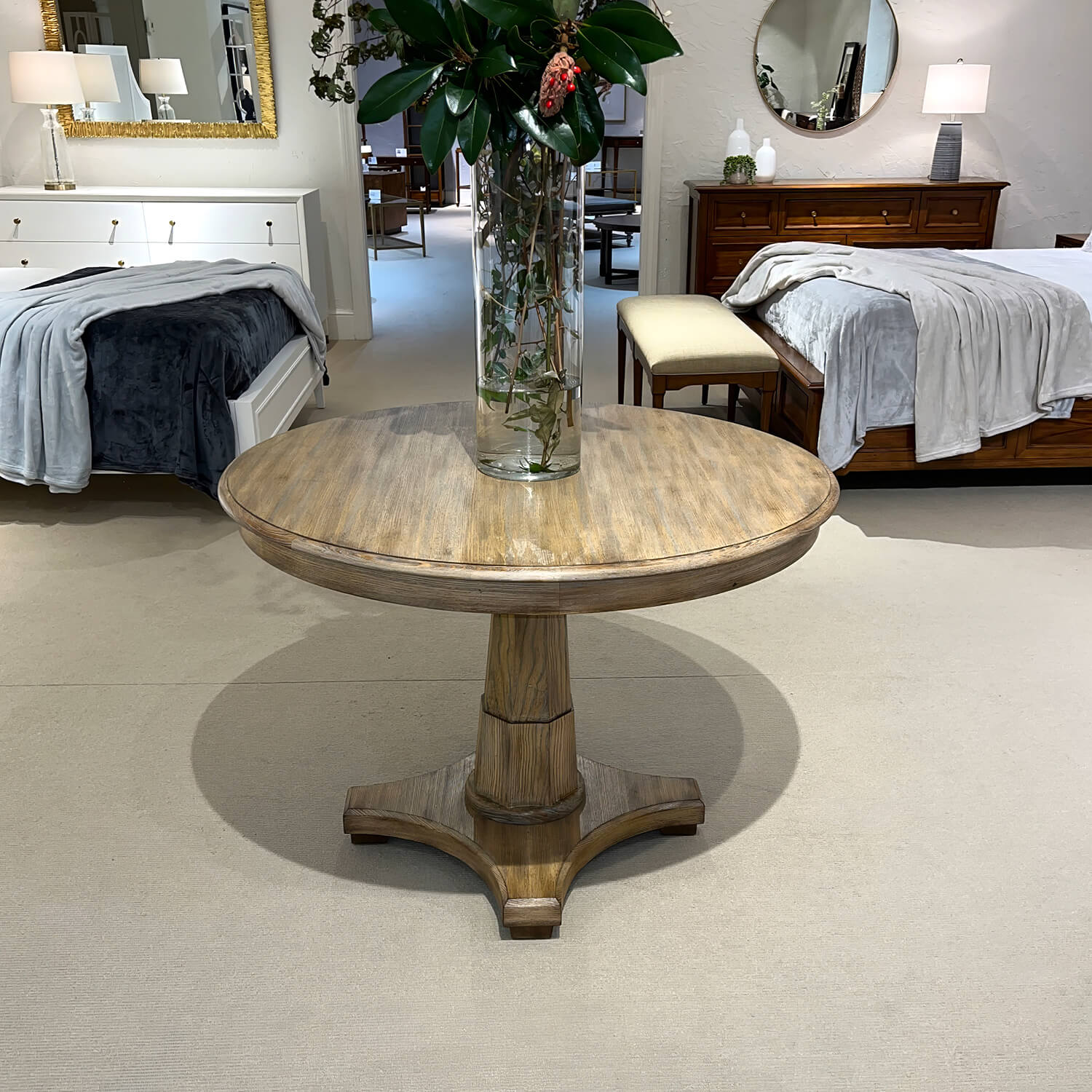 Center table in elegant showroom display with bedding.