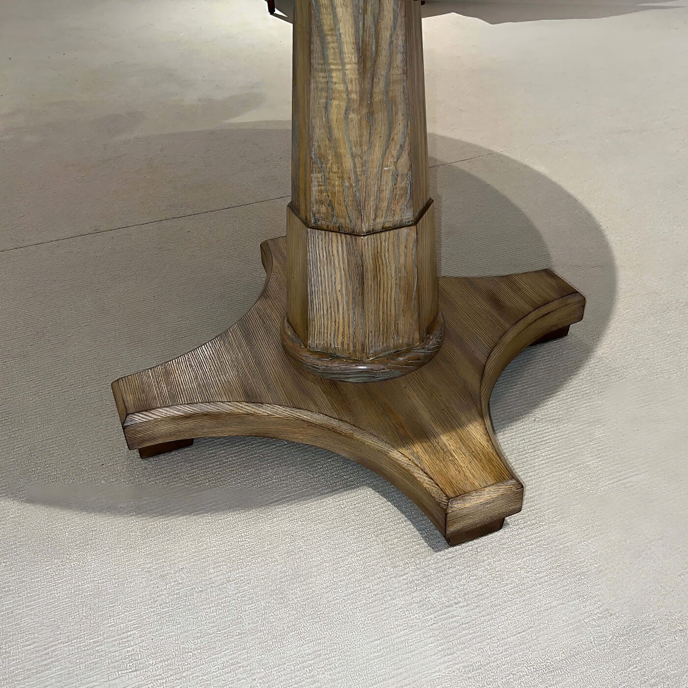 Close-up of pedestal base on center table.