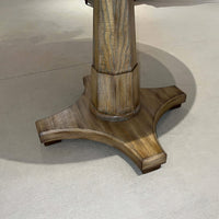 Close-up of pedestal base on center table.