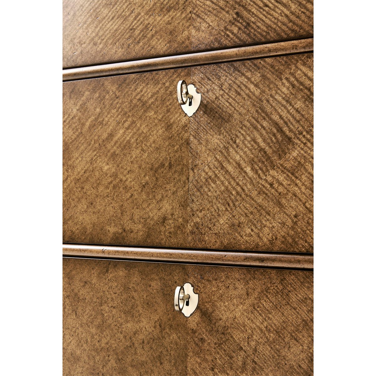 Close-up of drawer handles on English tall dresser.