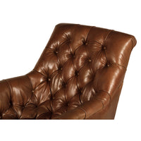 Tufted leather club chair backrest detail, button accents.