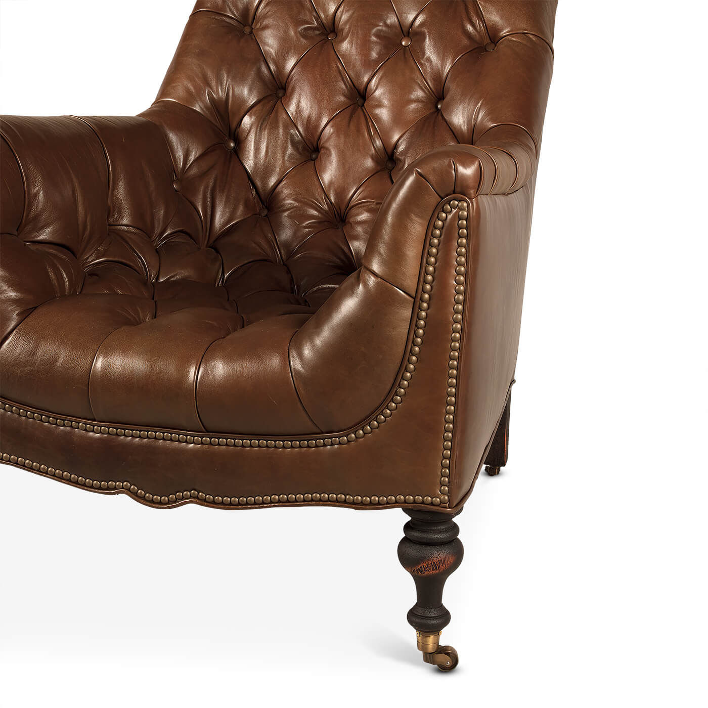 Close-up tufted leather club chair armrest, nailhead trim.
