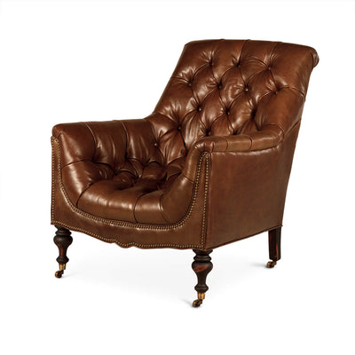 Brown tufted club chair angled view, leather upholstery, casters.