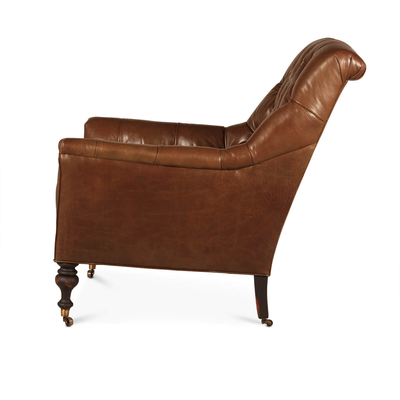 Side profile of classic tufted leather club chair.