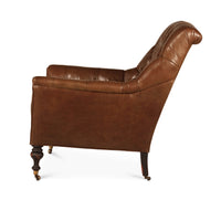 Side profile of classic tufted leather club chair.