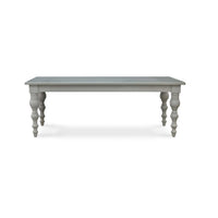 Front view of grey farmhouse dining table, turned legs.