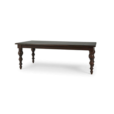Dark wooden dining table front corner view.