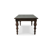 Dark wooden dining table side view.