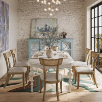 Dining room with credenza in background, table set.