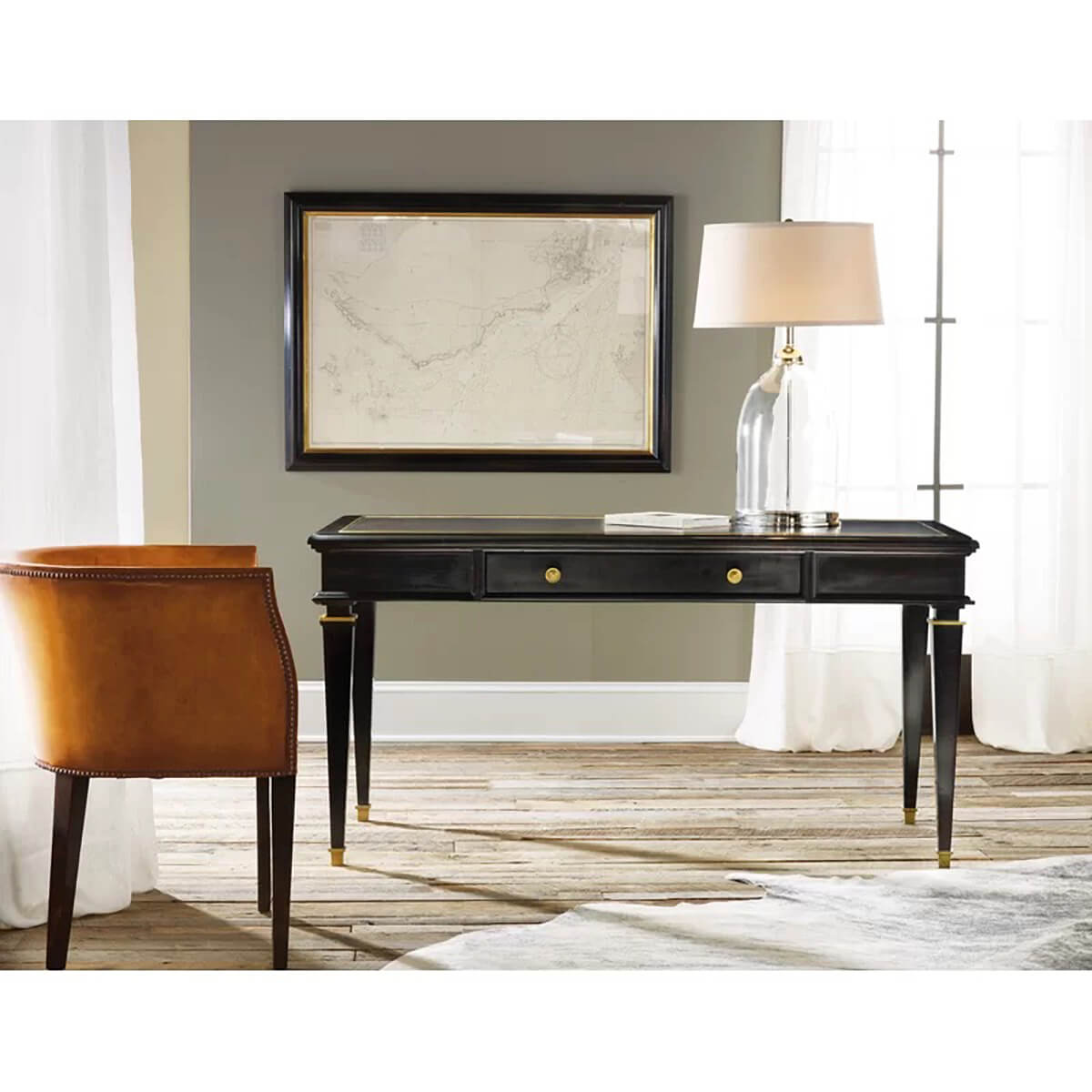Office setting with black desk and leather chair.