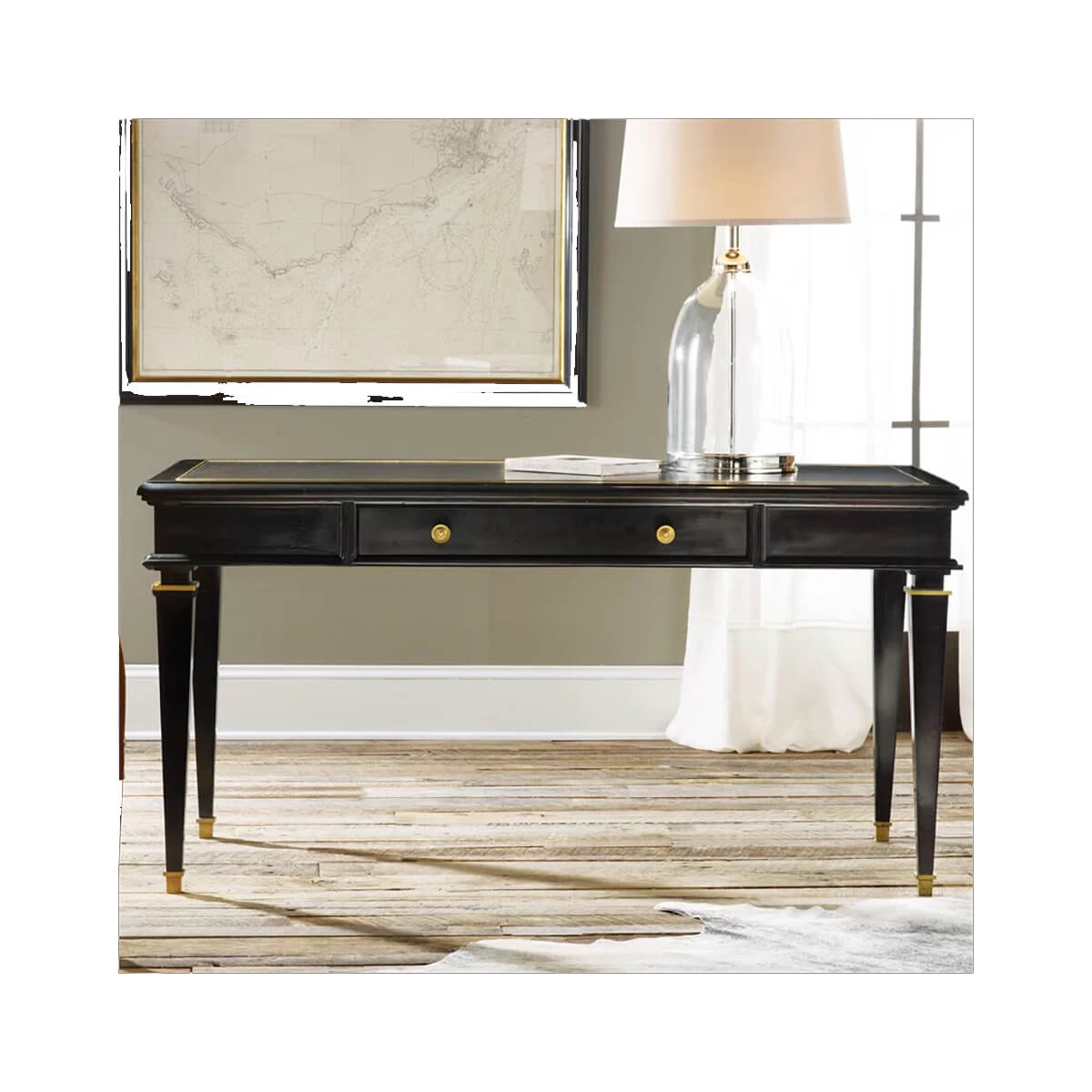 Side view of black desk near window with lamp.