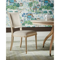 Classic French dining chair next to round dining table.
