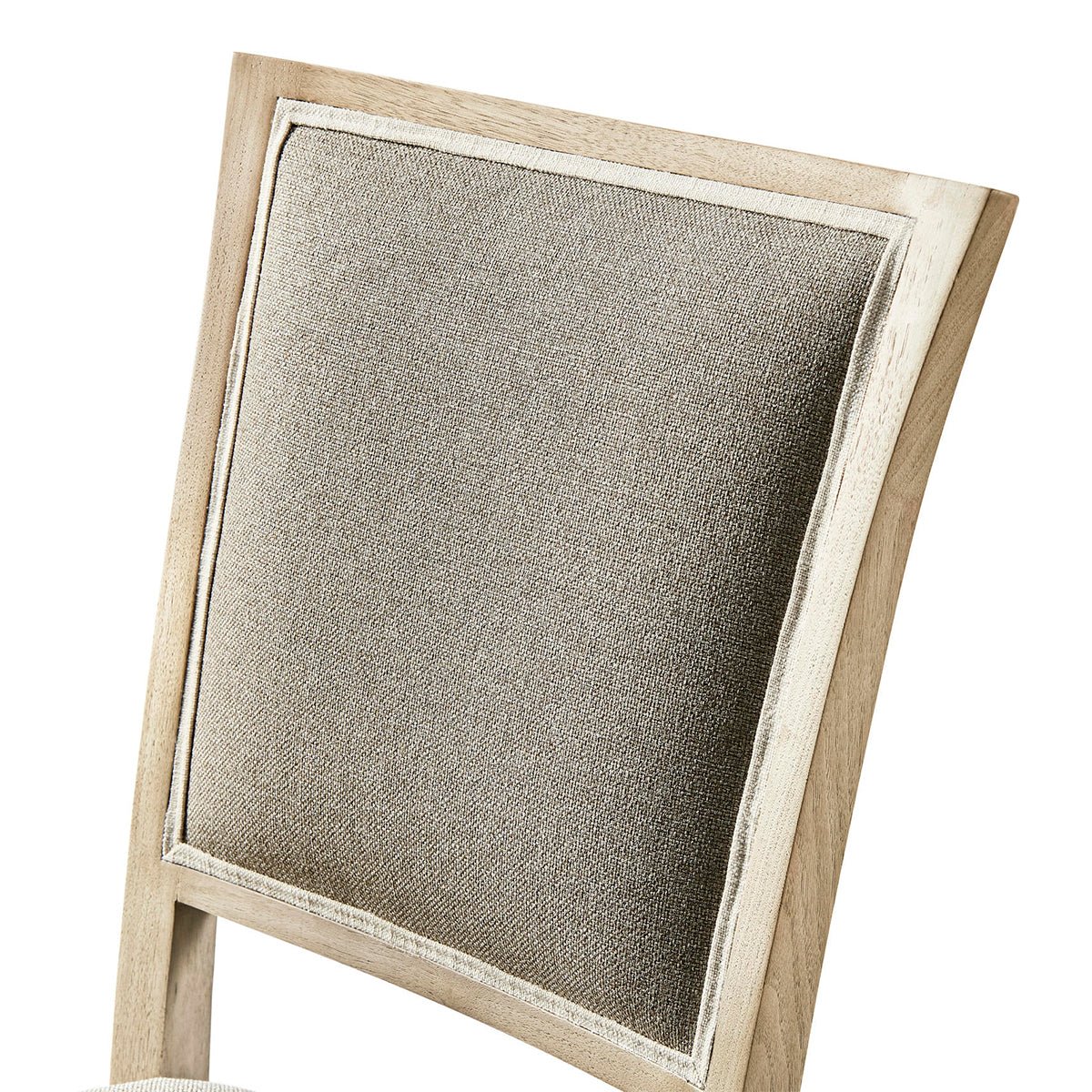 Close-up of upholstered backrest on classic French dining chair.