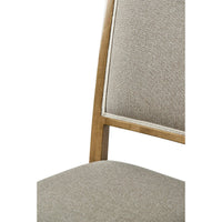 Close-up of dining chair seat, cherry finish.