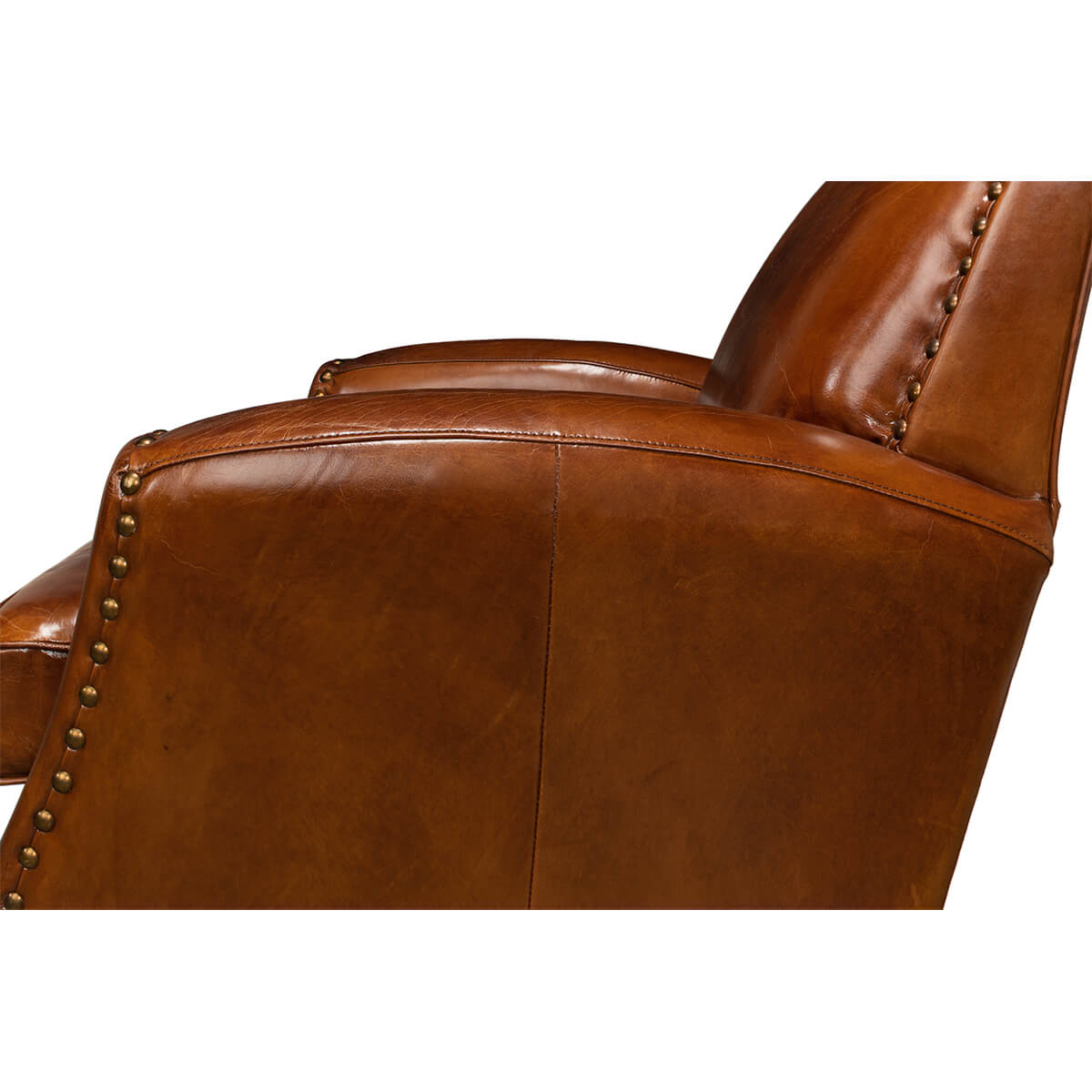 Side close-up of brown leather armchair arm and side.