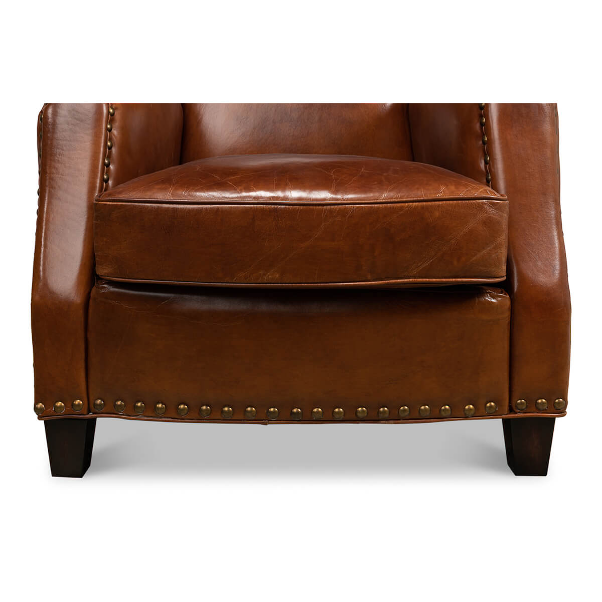 Close-up of brown leather armchair base and legs.