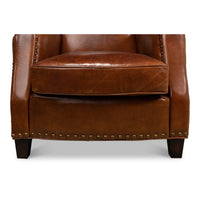 Close-up of brown leather armchair base and legs.