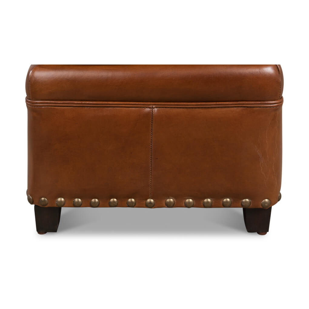 Back view of leather ottoman with decorative nailheads.